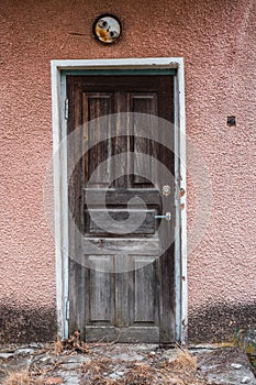 Wooden door in an old abandoned house. Brown textured door