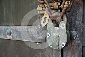 Wooden door with old chain and padlock