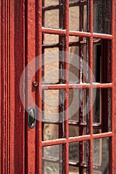 Wooden door of an old red telephone box