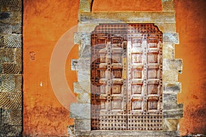 Wooden door in an orange wall