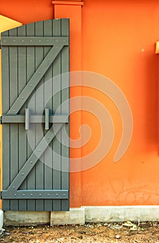 Wooden door on the orange wall.