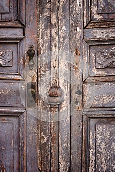 Wooden door with ornately-crafted door knobs