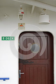 Wooden door with a porthole on ship