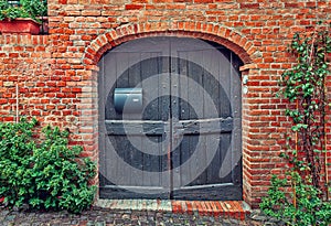 Wooden door and red brick wall.