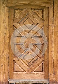 Wooden door with rhombus shape ornament planks in brown color texture