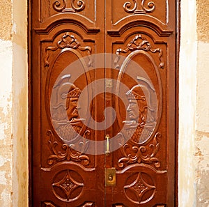 Wooden door with Roman soldiers in Caceres, Spain