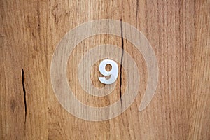 Wooden door of the room in the hotel with number 9