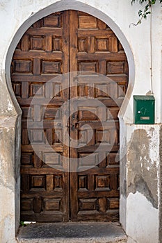 A wooden door with a round arch. arabic door