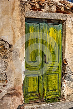 Wooden door in a rustic wall in Nuoro photo