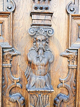 Wooden door sculptured with embossed elements