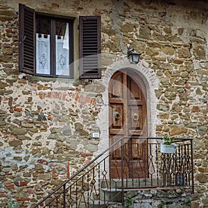 Wooden door in a small village of medieval origin. Volpaia, Tuscany, Italy