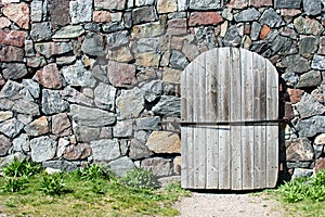 Wooden door and stone wall.