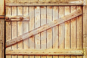 Wooden door to the barn or horse stall, lock on the door.