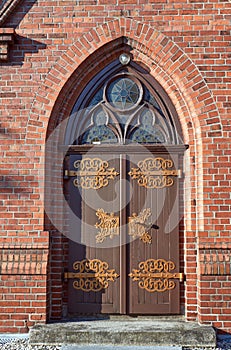 The wooden door to the Gothic church