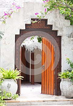 Wooden door of the tropical garden villa