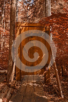 Wooden door on a walk way through the forest