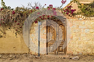 Wooden door in a wall in the village of Faiyum