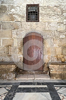 Wooden door and window covered with interleaved wooden grid photo