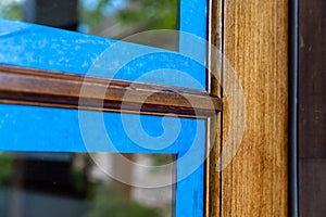 Wooden door with window, taped off with paint`s tape