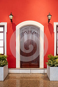 Wooden door with windows. Portugal Windows. Bright red colored facade of house