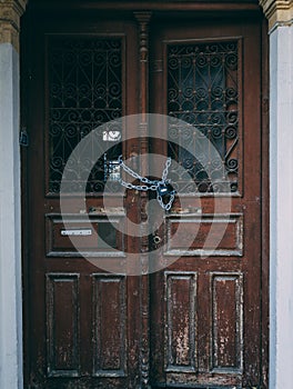Wooden doors of empty building locked with chain
