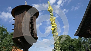 Wooden Dovecote with a roof against a blue sky