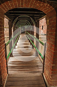 Wooden drawbridge and walkway over water filled moat at De Haar Castle, near Utrecht.