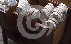 Wooden drawer full of white espadrille shoes