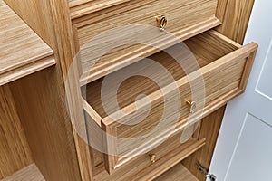 Wooden drawers of wardrobe close-up. Wooden wardrobe with wooden drawers and shelves. Wooden filling of wardrobe