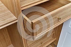 Wooden drawers of wardrobe close-up. Wooden wardrobe with wooden drawers and shelves. Wooden filling of wardrobe