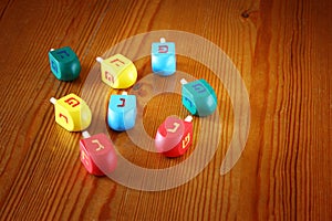 Wooden dreidels for hanukkah on wooden table.