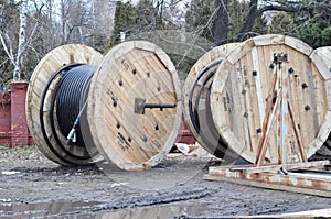 Wooden drums of electric cables, optical fibres on the construction site. Spool of cabels
