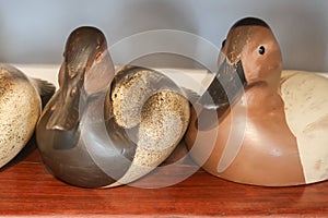 Wooden duck decoys on a shelf. photo