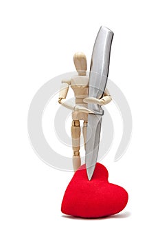 wooden dummies with a knife stabbing into a red heart, isolated