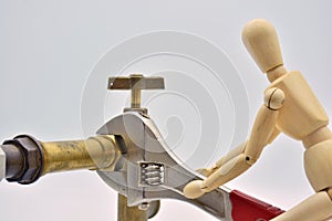 Wooden mannequin with an adjustable wrench photo