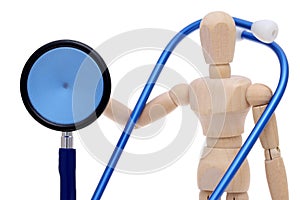 Wooden dummy hand holding stethoscope