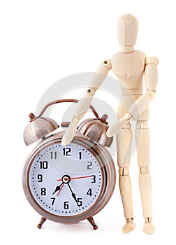 Wooden dummy with old-styled alarm clock