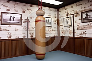 a wooden dummy used for wing chun training in a dojo