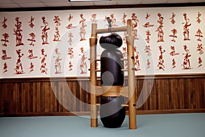 a wooden dummy used for wing chun training in a dojo