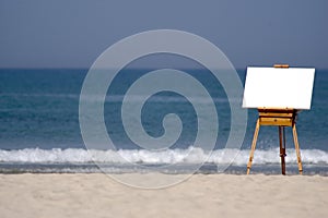 Wooden Easel and Blank Canvas on Beach photo