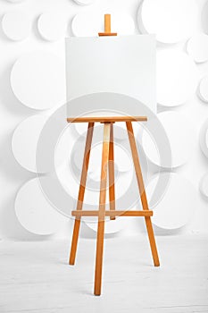 Wooden easel with blank canvas in the studio