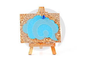 Wooden easel with corkboard and blue speech bubble