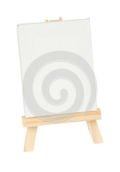 Wooden easel with empty white canvas