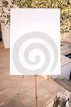 Wooden easel with white paper