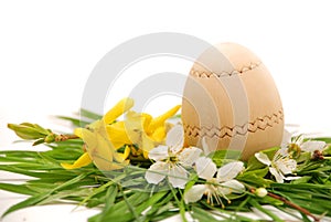 Wooden easter egg in a colorful spring nest