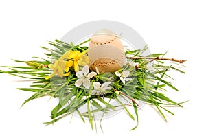 Wooden easter egg in a colorful spring nest