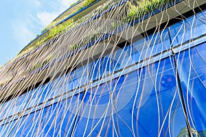 Wooden eco texture on the facade of a modern building. Background with selective focus