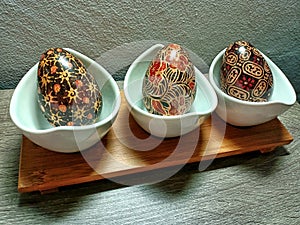 wooden egg display on table with Indonesian batik motif. Placed on a wooden table.