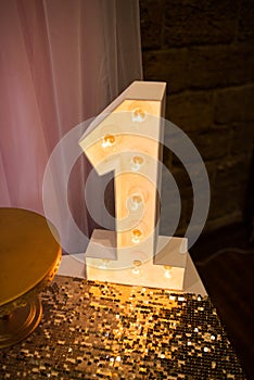 Wooden electric light up lamp alphabet in hard font. Number 1. Wooden number 1 with bulbs.