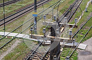 Wooden electric pole with high voltage wires close-up. Old decrepit wooden post at the railway station